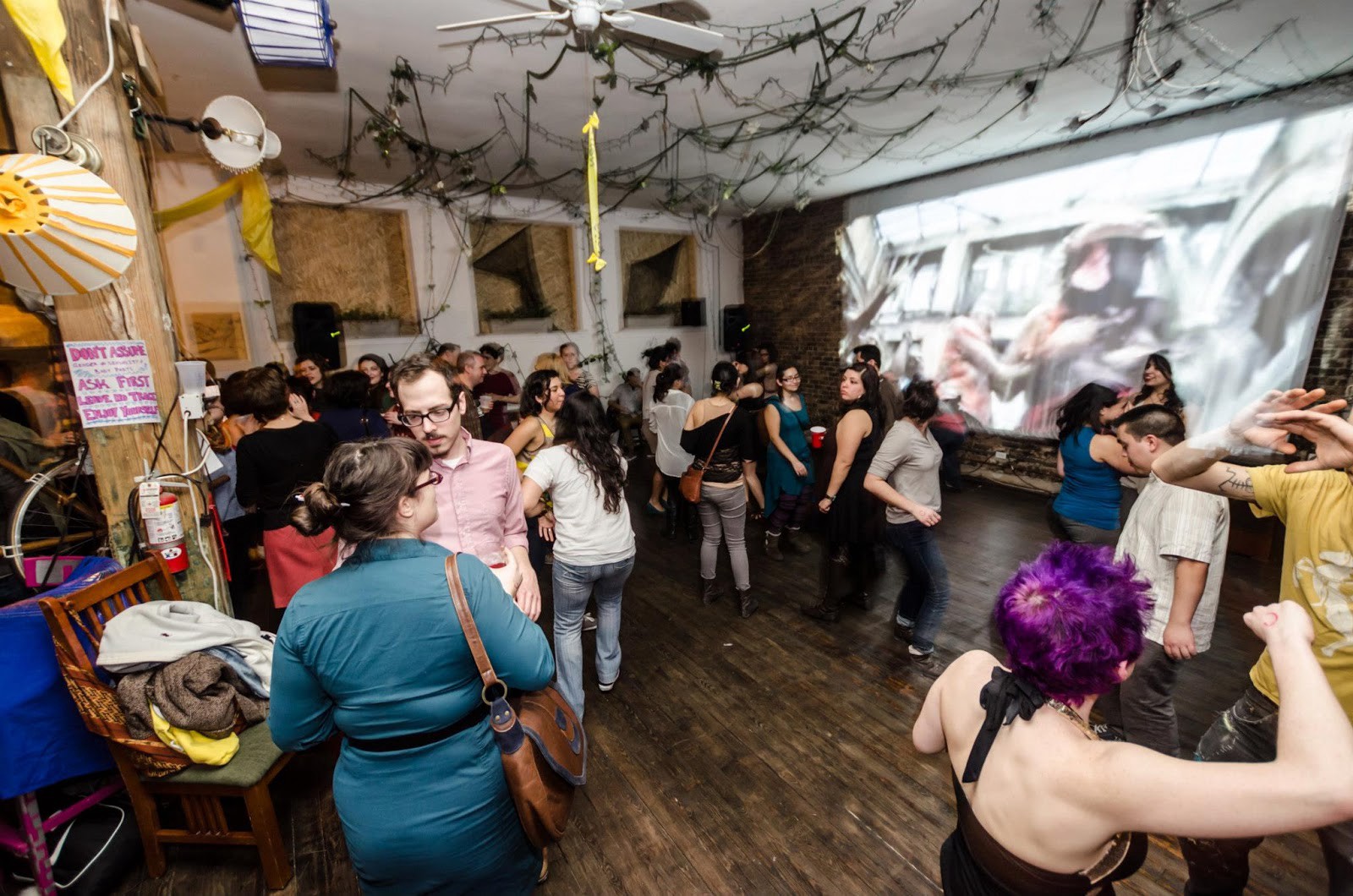 An Occupy Chicago fundraiser at the ribcage. note the homemade big ole projector screen and the diy soundproofing in the windows. Also the sideways lamps on the left (that was my idea).