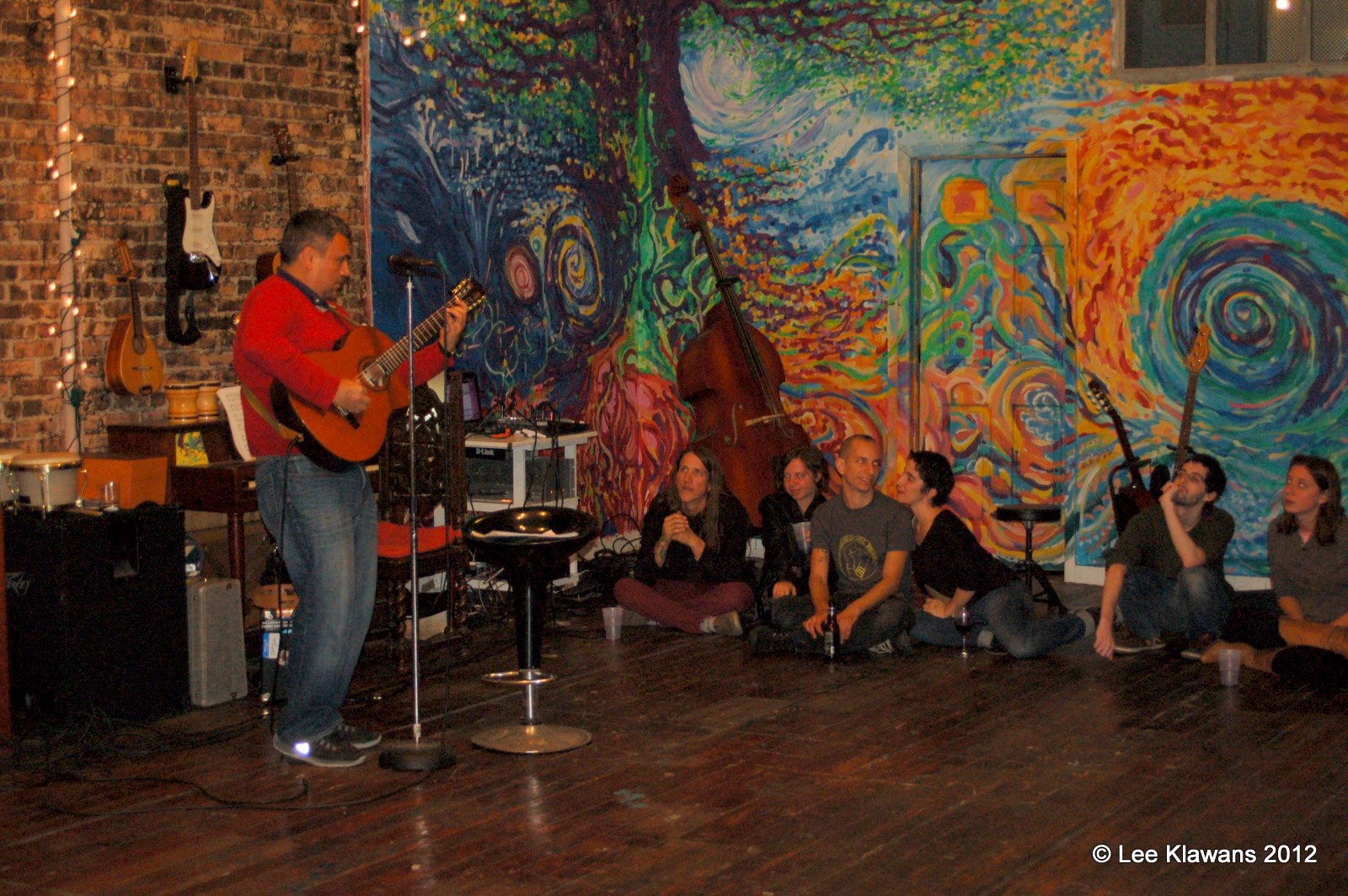 *acoustic show. most of the crowd is to the right out of frame. we all adored the mural we created together — I heard that the people who moved in after us painted over it right away.*